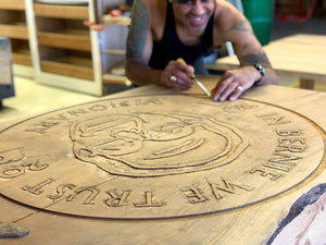 Photo of Del Fine Artist working on Head of Table wood carving